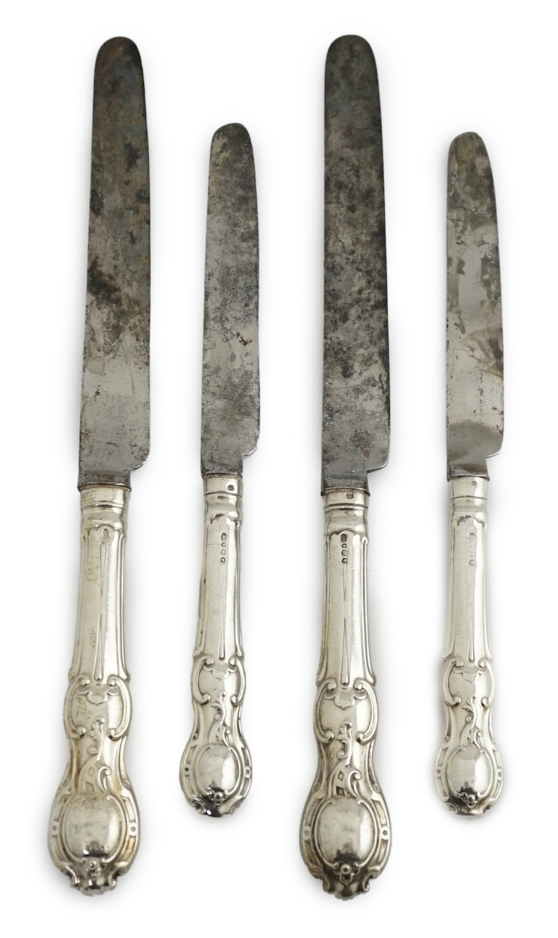 A matched set of nine Victorian silver rococo handled table knives, with steel blades, and eight matched Victorian silver rococo handled dessert knives.